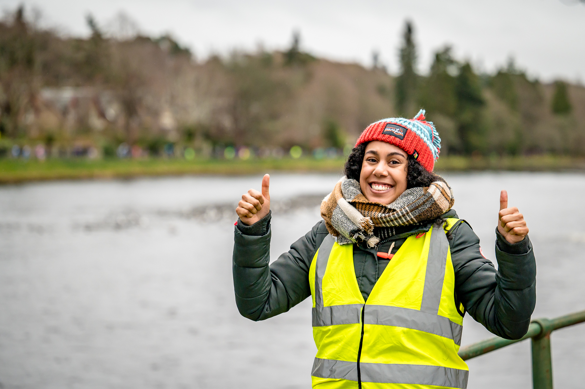 A volunteer gives the camera a double thumbs up